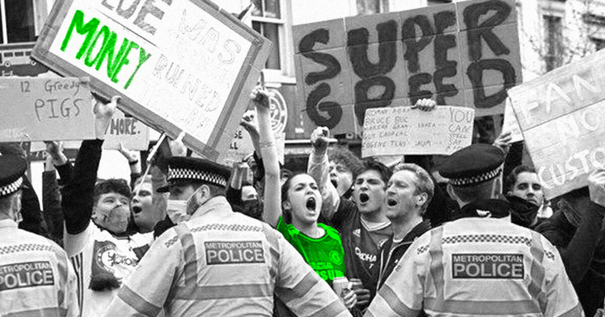 football fans with placards protesting with police holding them back